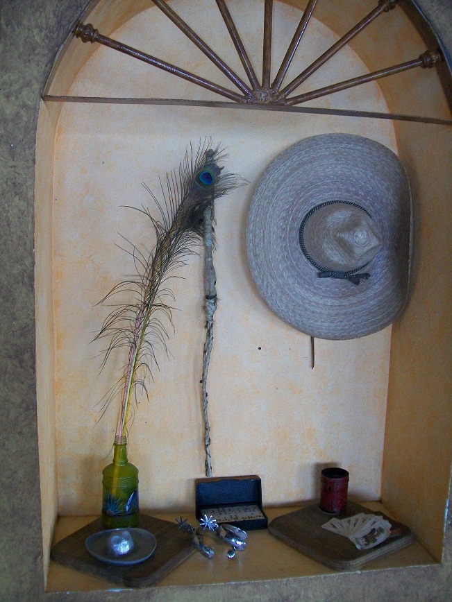 dominoes, spurs, playing cards, a dice cup, a sombrero, and a
peacock feather in the mouth of a green glass bottle